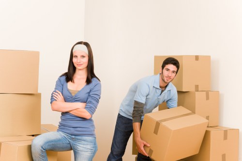 Local moving service unloading boxes near a Willesden property